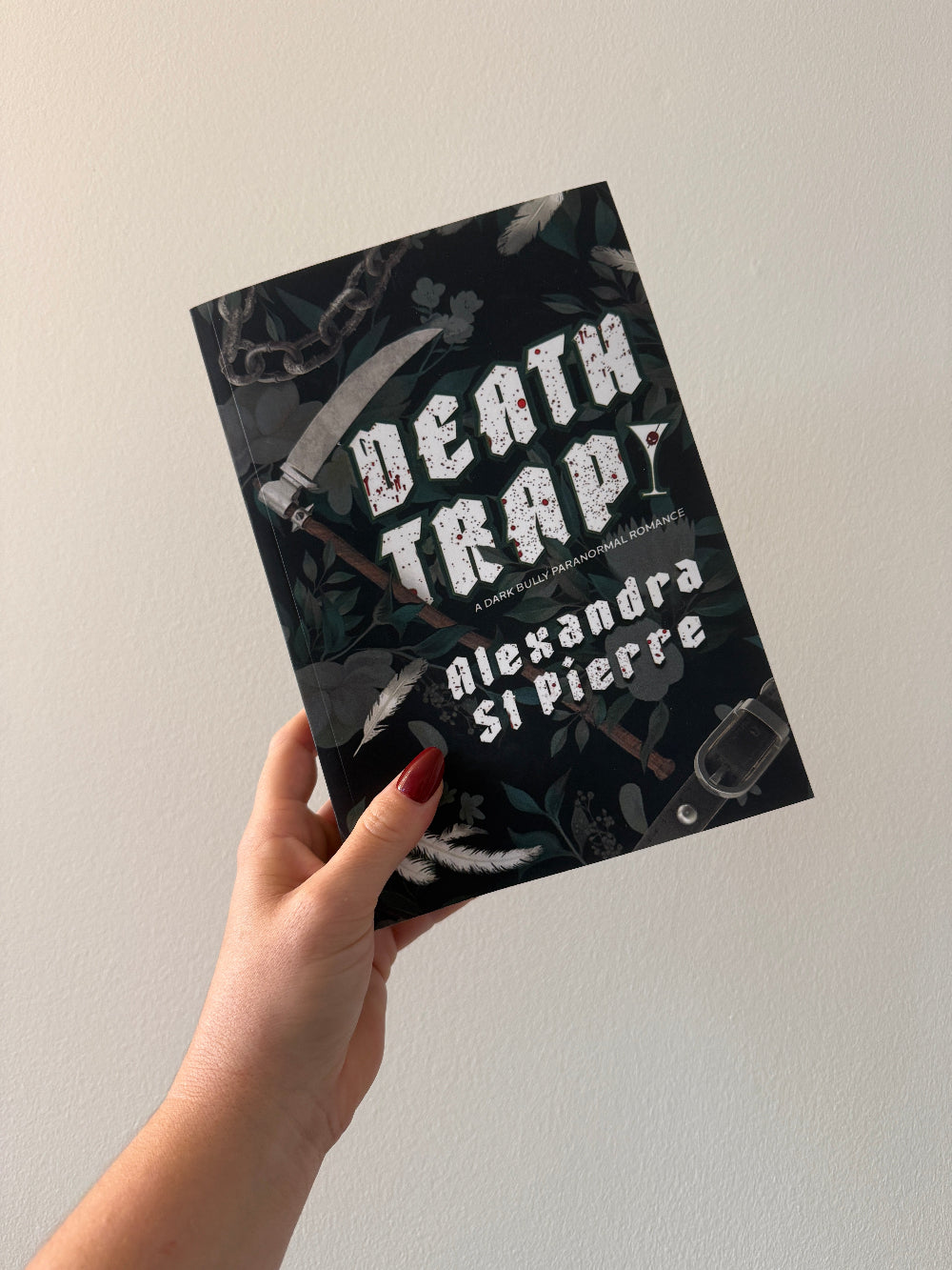 Picture of hand holding Deathtrap book